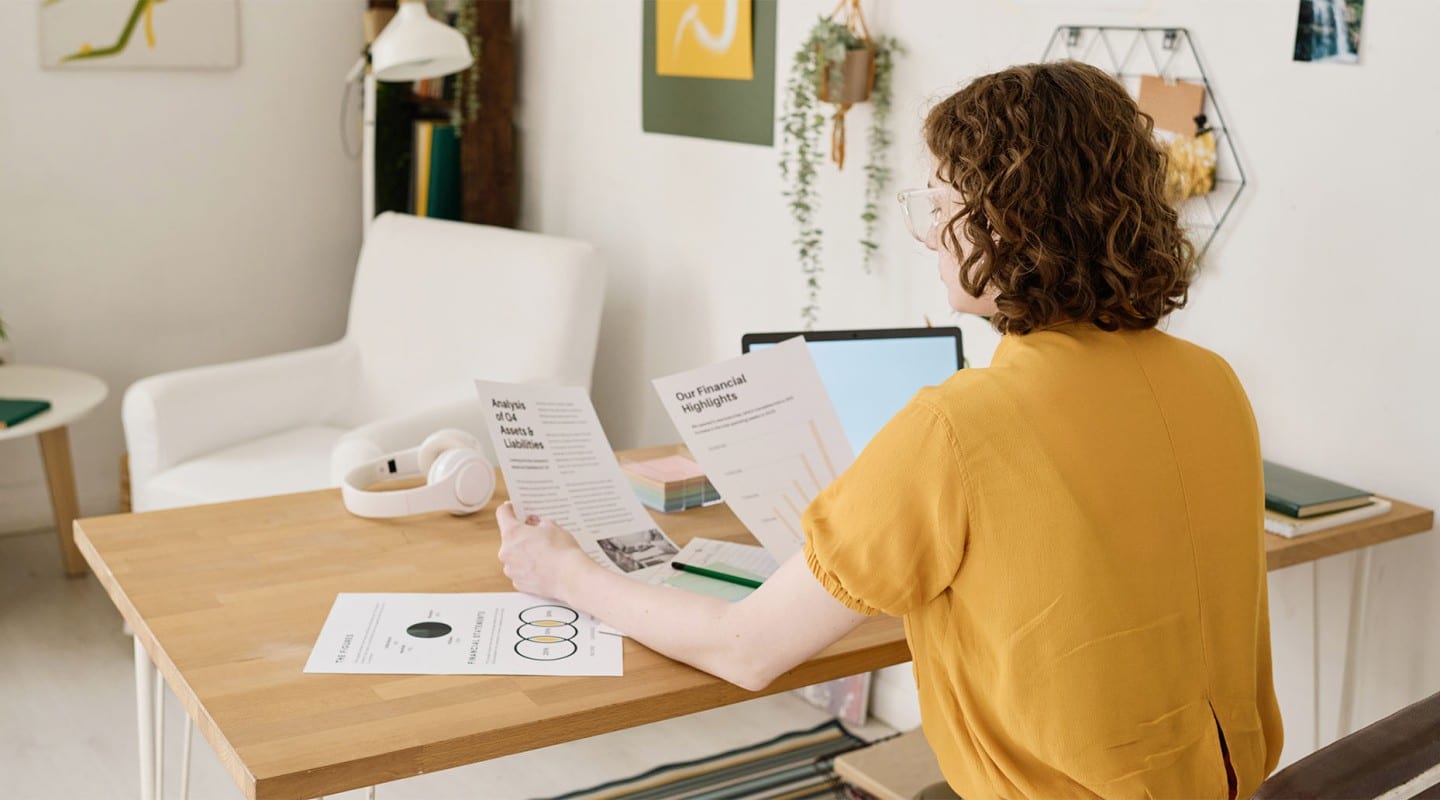 woman reading etf and mutual fund fact sheet